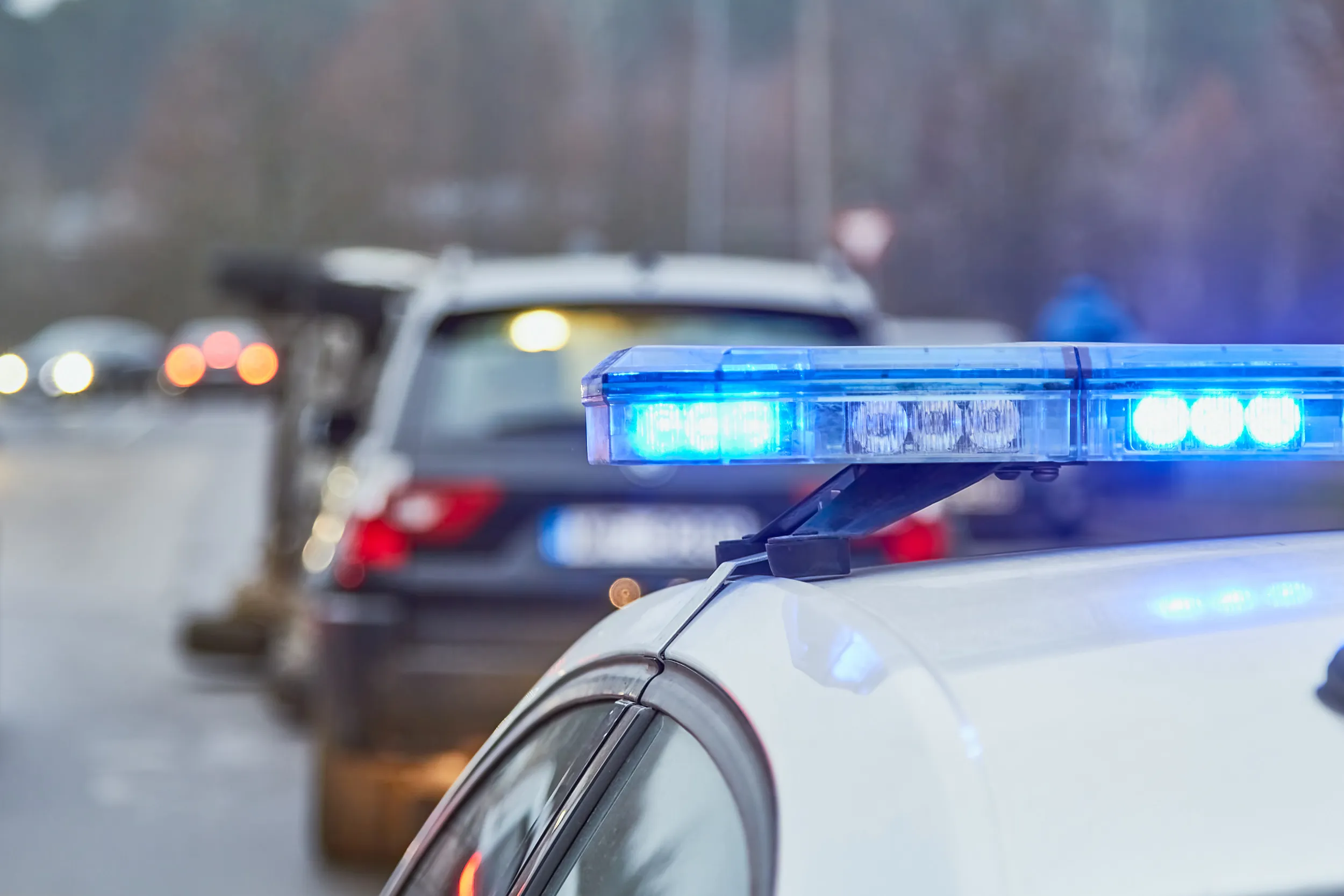 Police officer pulling car over. Our team of traffic lawyers in Kansas City can help keep your driving record clear if you’ve committed a traffic violation and received a speeding ticket.